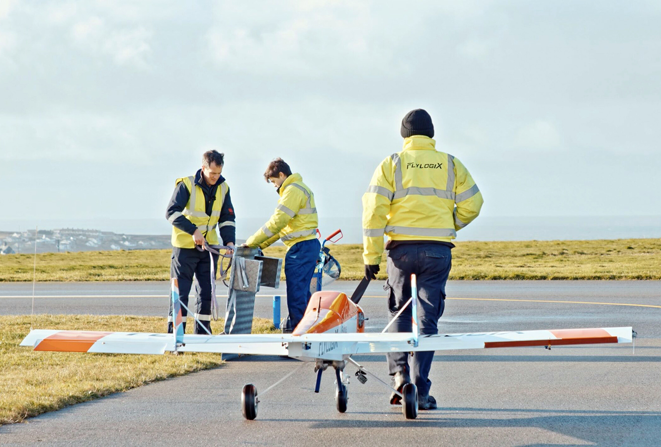 Flylogix team with BVLOS plane on a runway