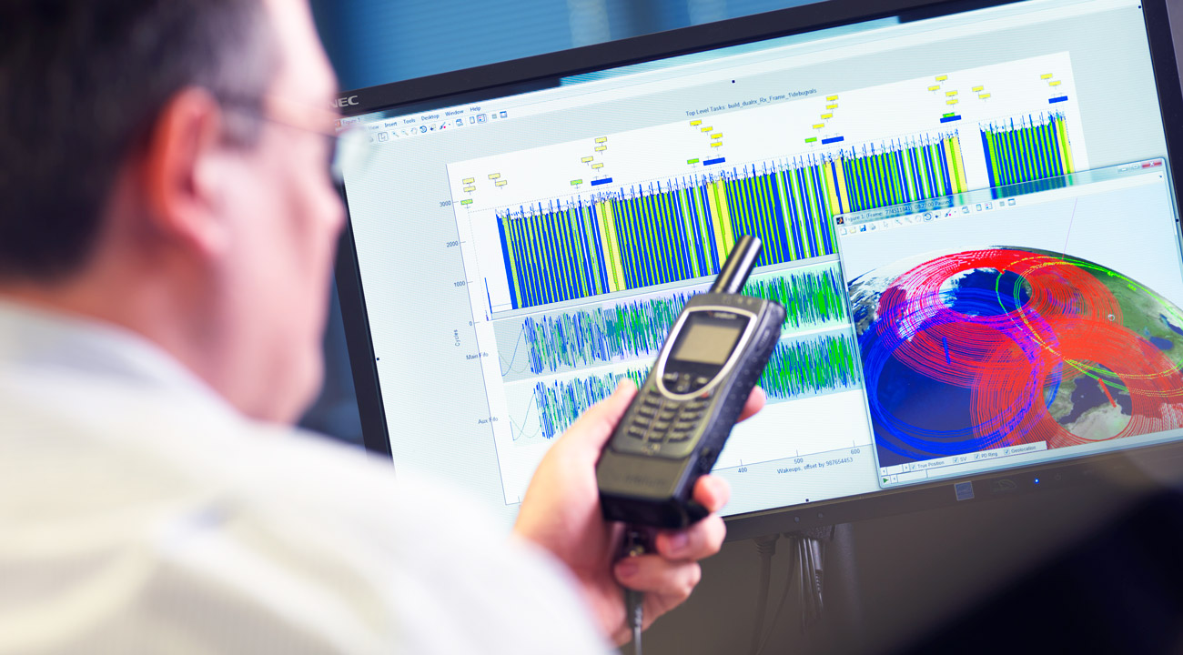 Cambridge Consultants engineer holding Iridium PPT satellite phone to measure performance