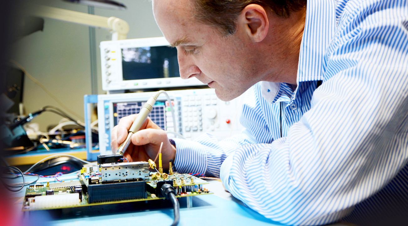 Cambridge Consultants engineer working in a technology lab on Iridum PPT project