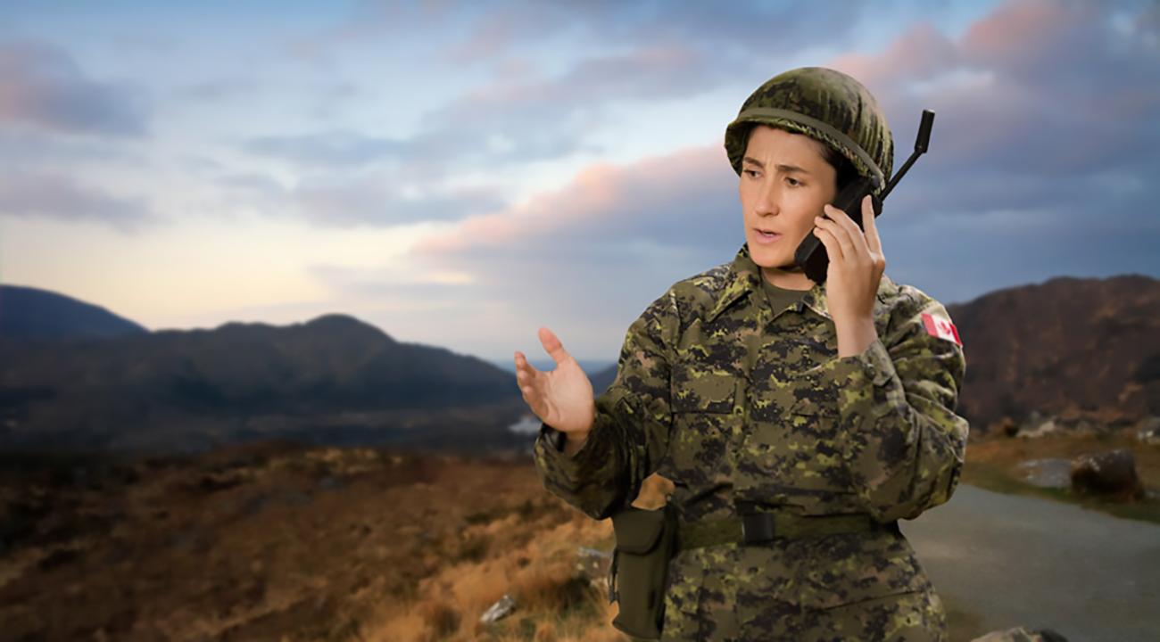 Emergency first responder speaking into Iridium PPT satellite phone in remote area